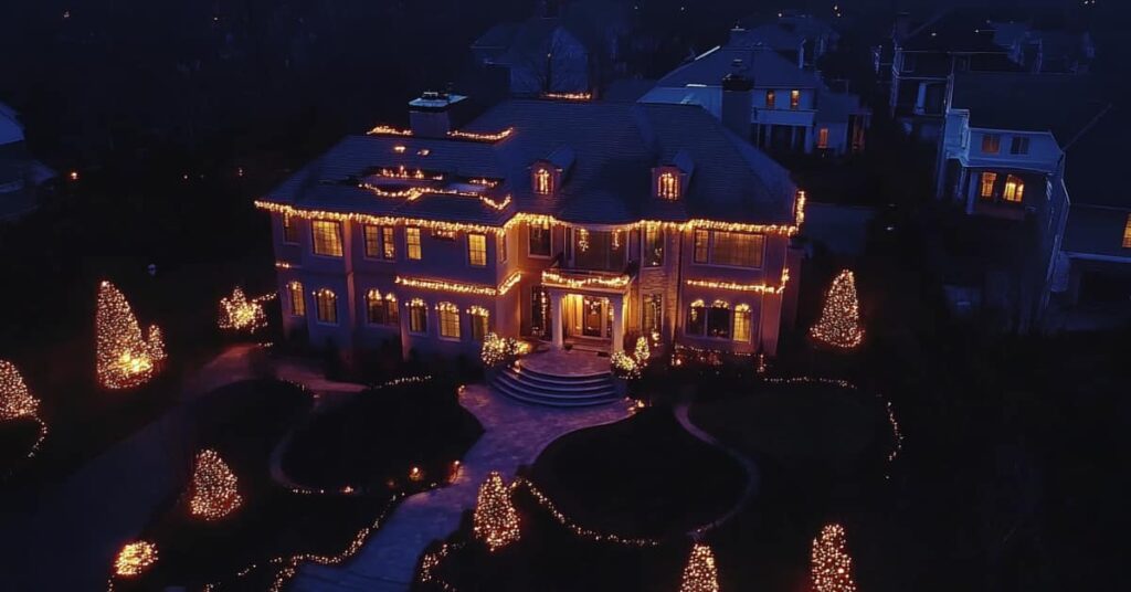 large home and trees lit up with Holiday Lighting, concept of a Retro Christmas Outdoor Lighting Display